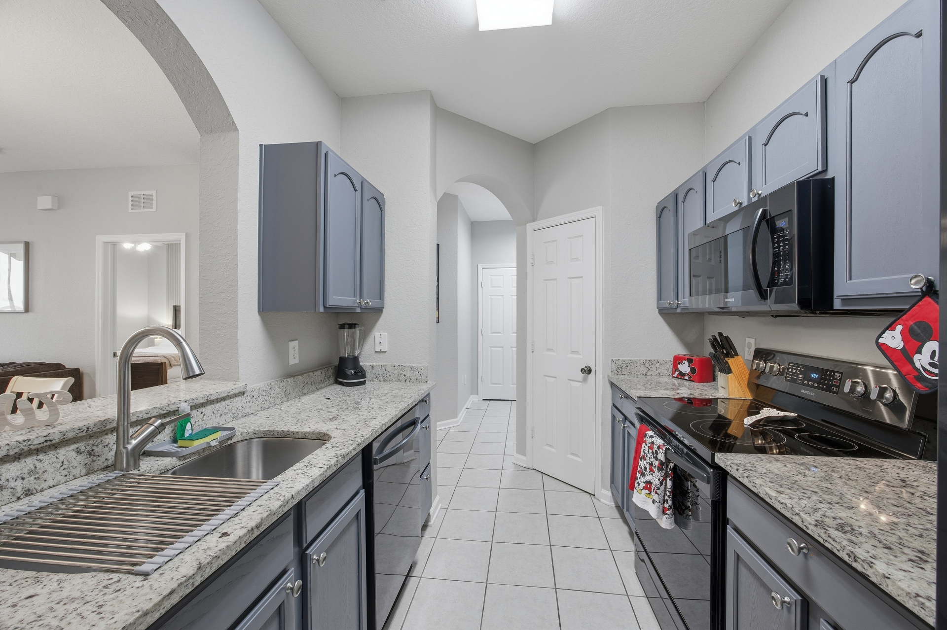 Kitchen view with sink, range, and prep space