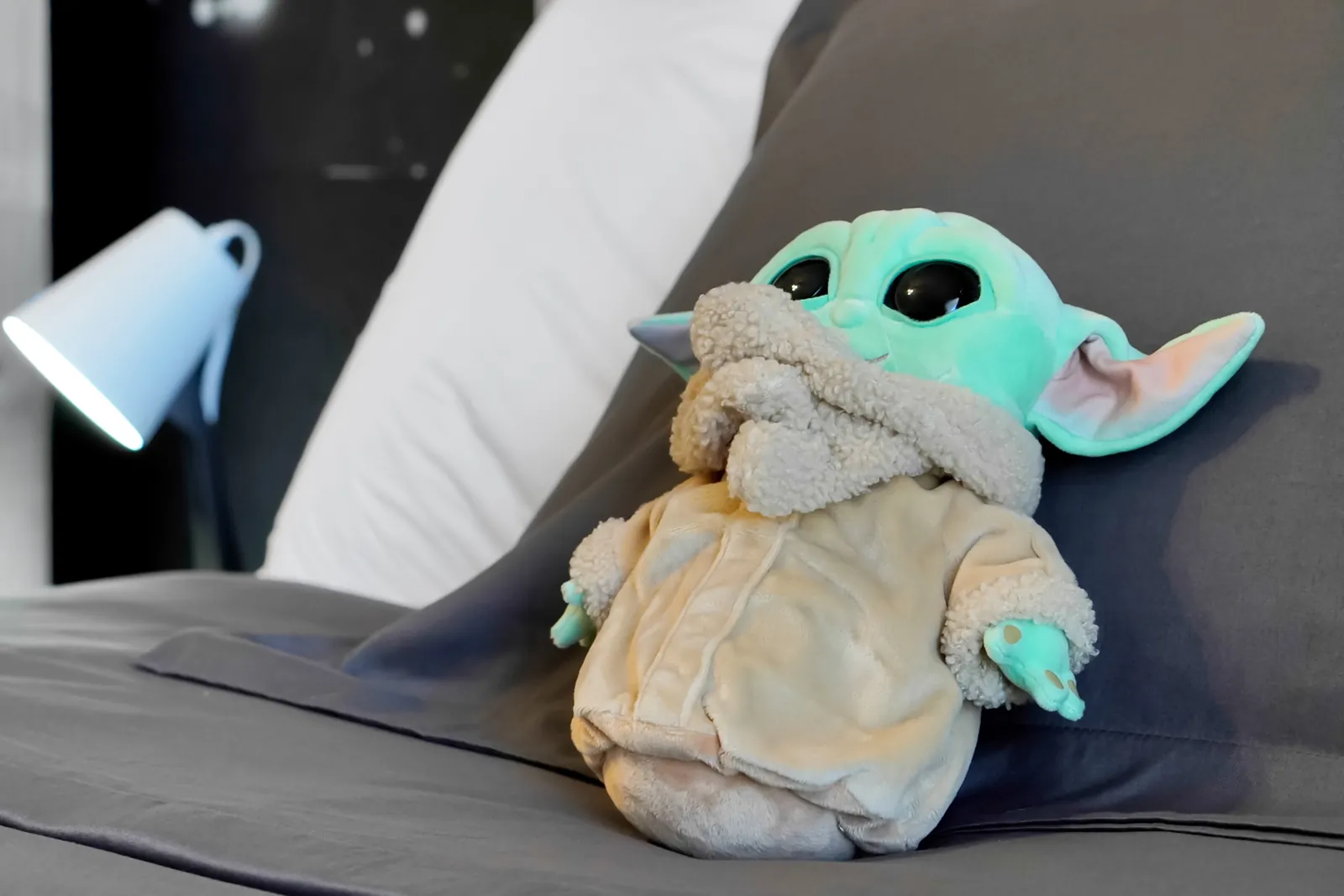 Grogu plush on the bed in the themed bedroom