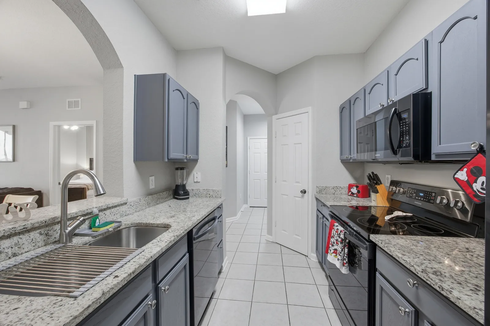 Kitchen view with sink, range, and prep space