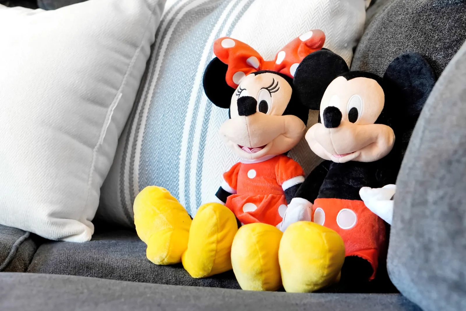 Mickey and Minnie plush toys on the living room sofa