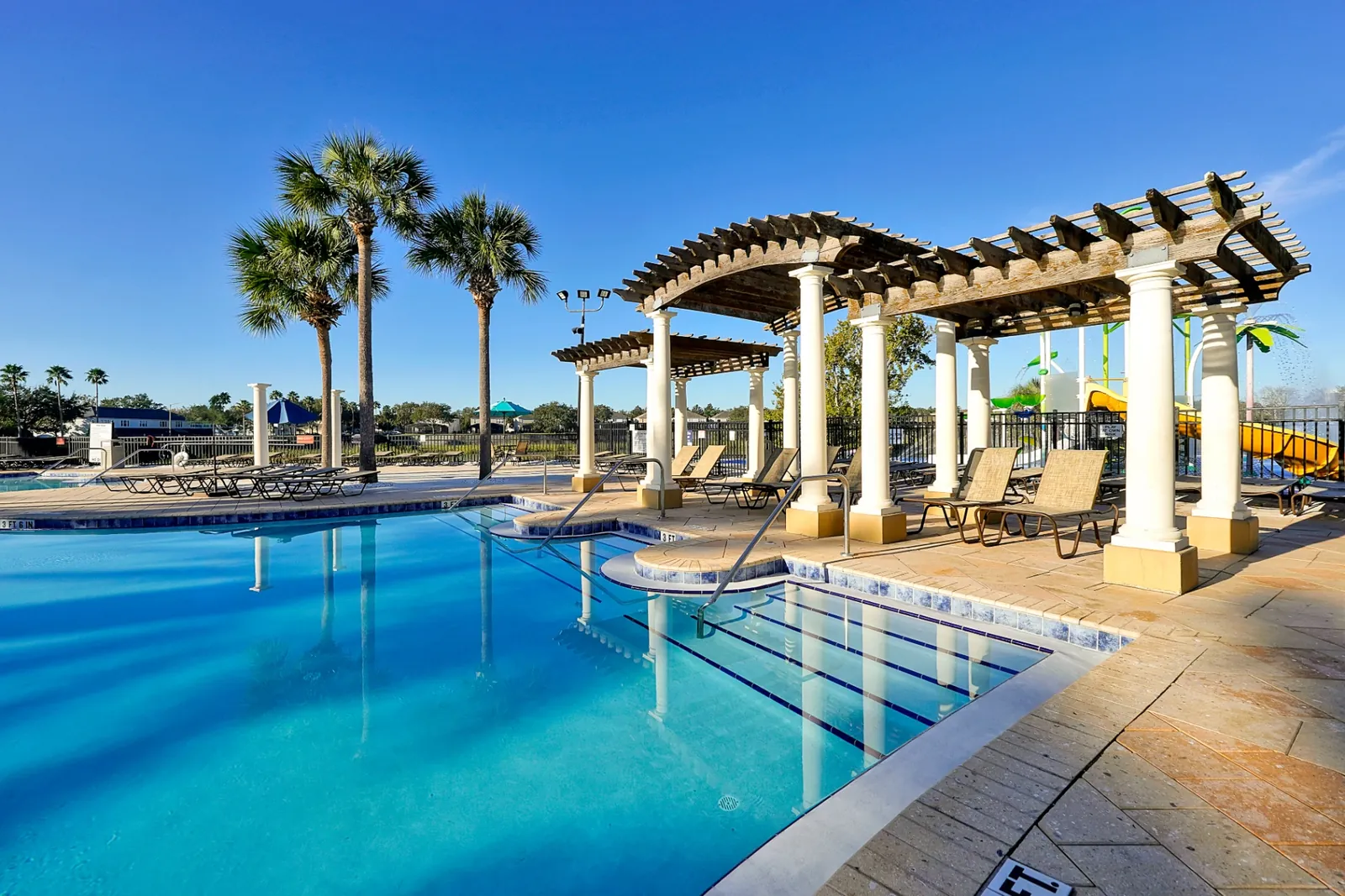 Resort pool with pergola shade and water slides