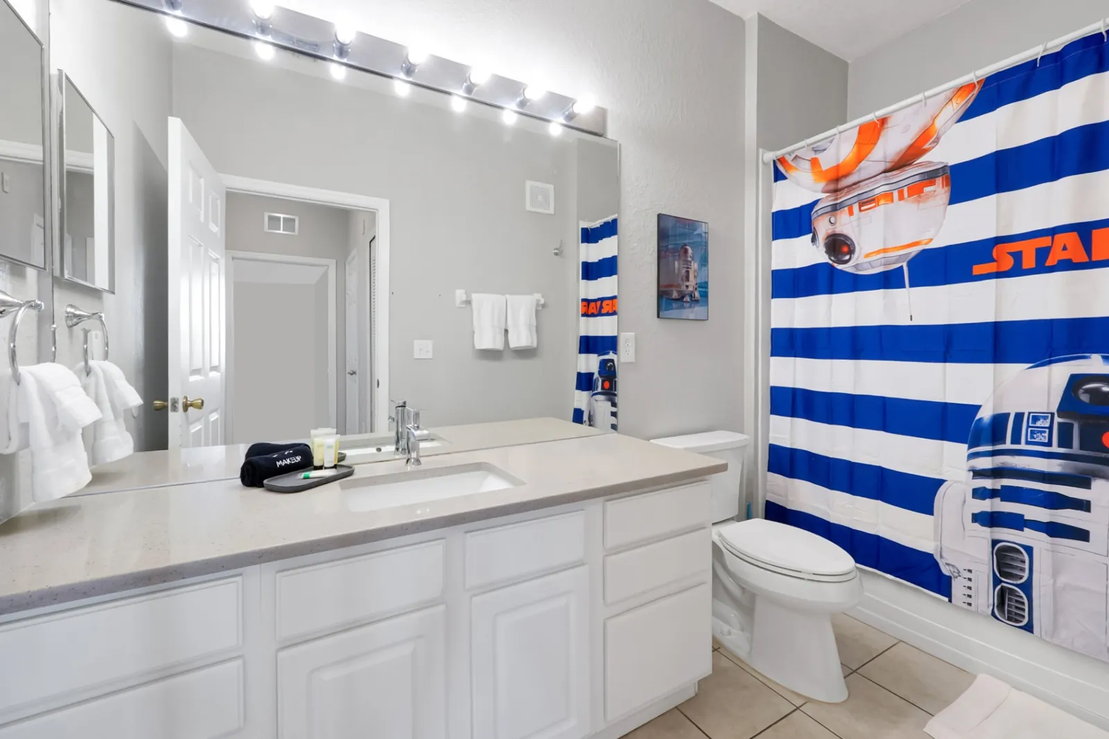 Star Wars themed secondary bathroom with R2-D2 shower curtain