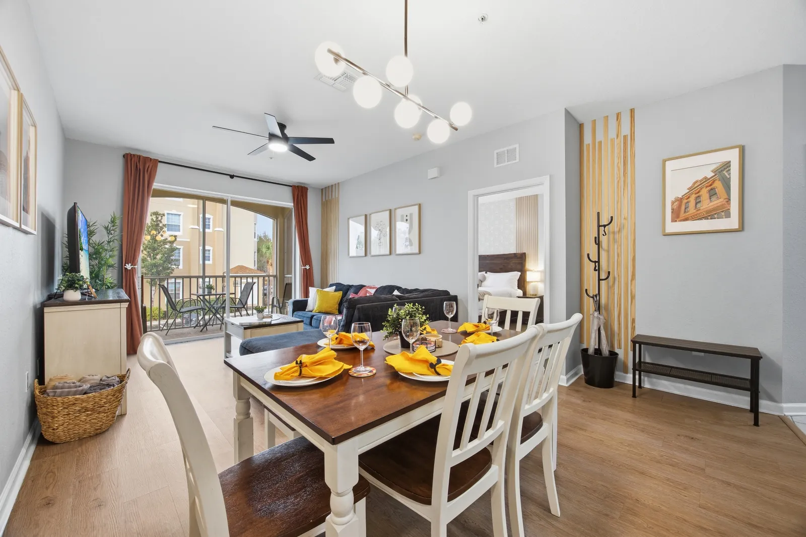 Open-concept dining and living area with Mickey Mouse artwork in the Windsor Hills Disney condo